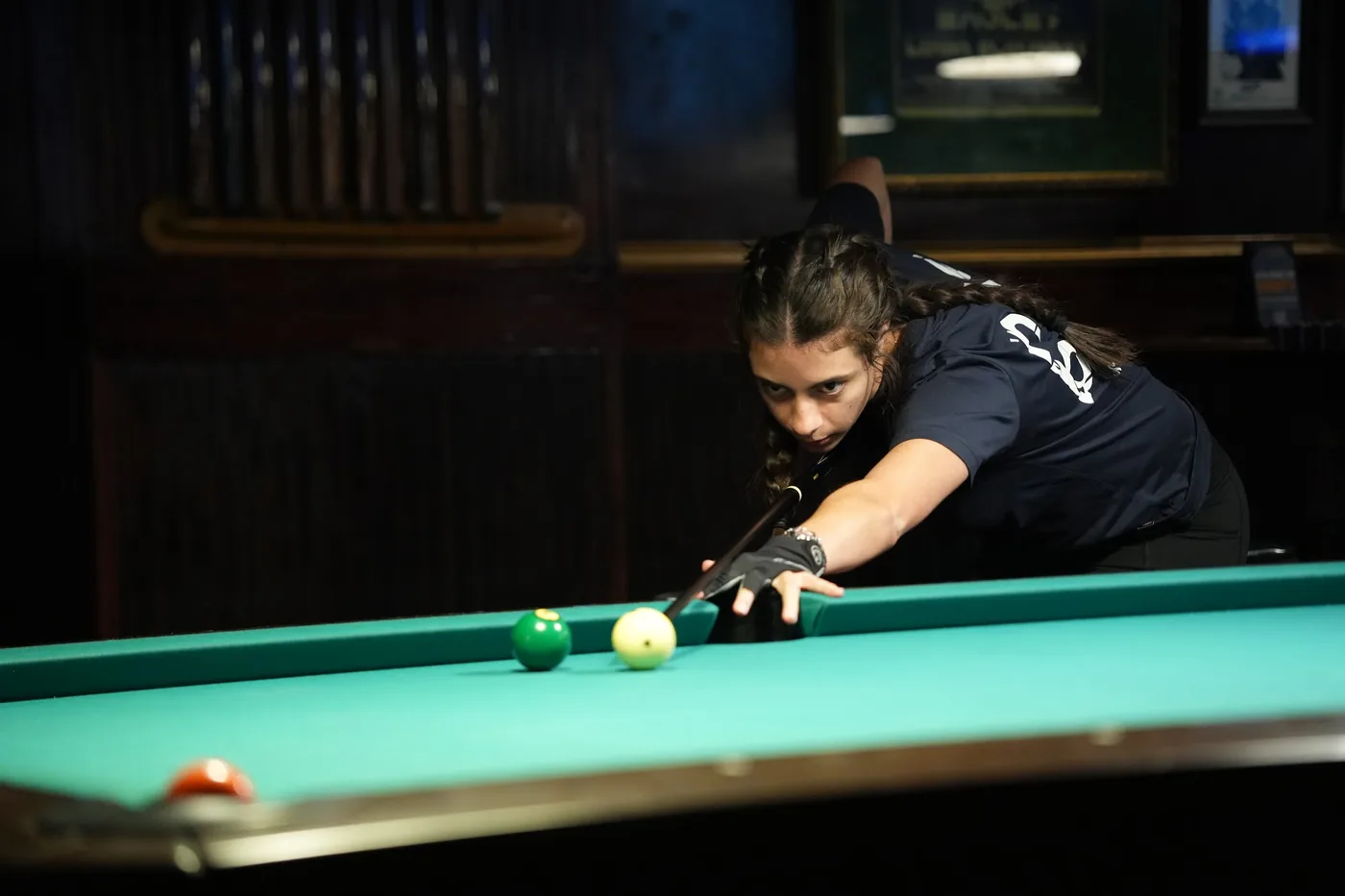 A player sighting down the cue at the cue ball on the Saturday night of the 10-Ball qualifier.